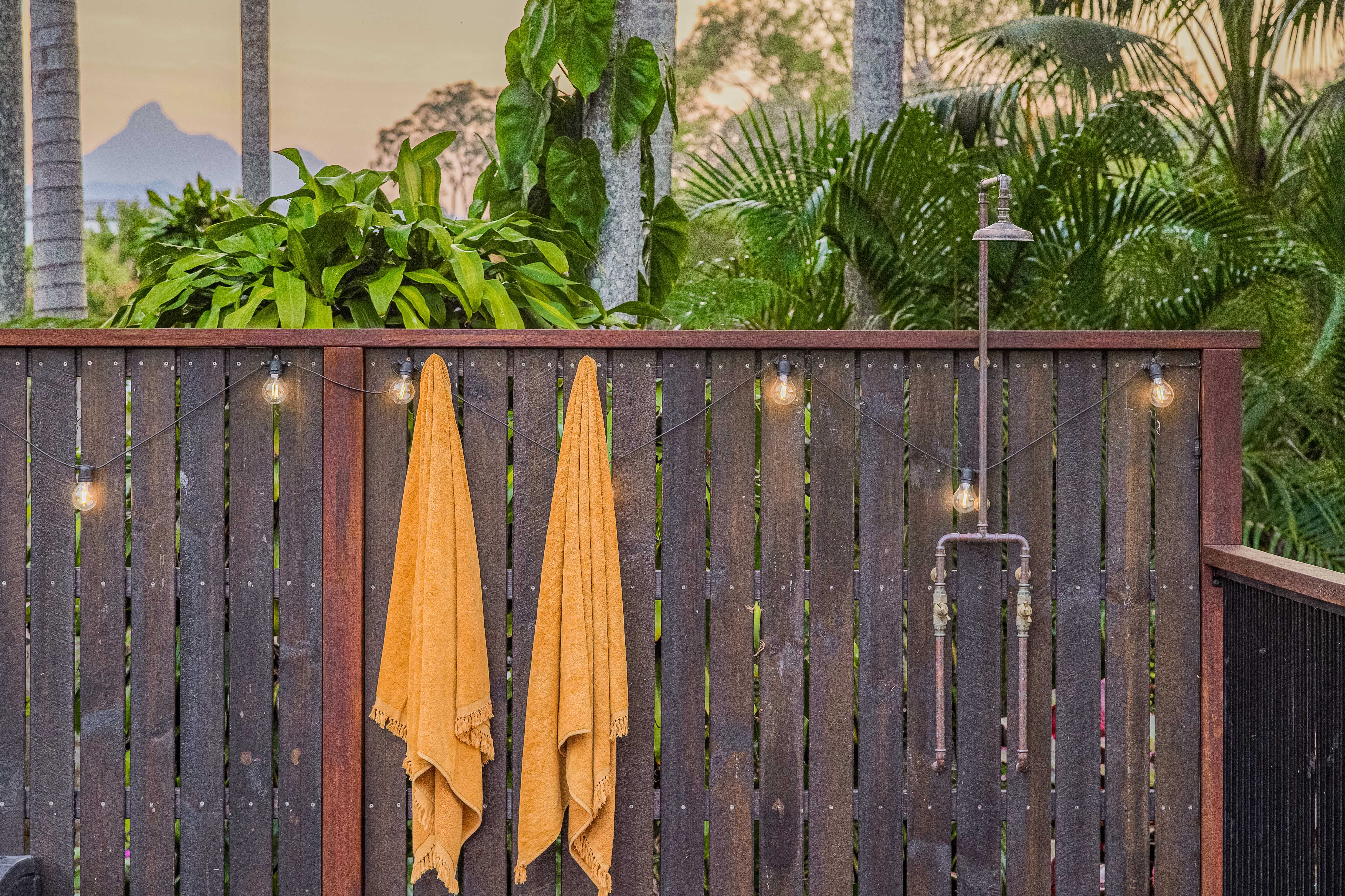 bali inspired backyard pool shower