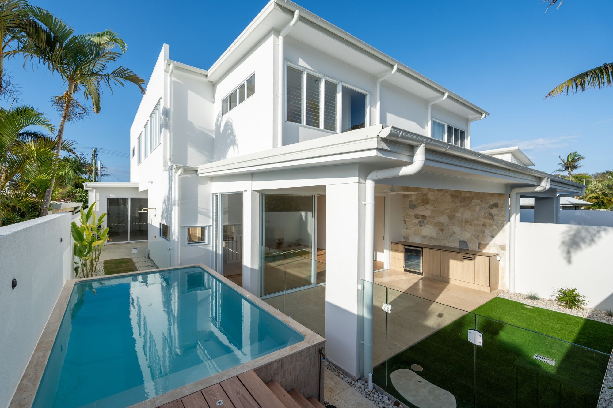 A Plungie Studio (3.6 x 2.2m), a rectangle plunge pool that's been installed above-ground - maximising the limited space for this coastal backyard.
